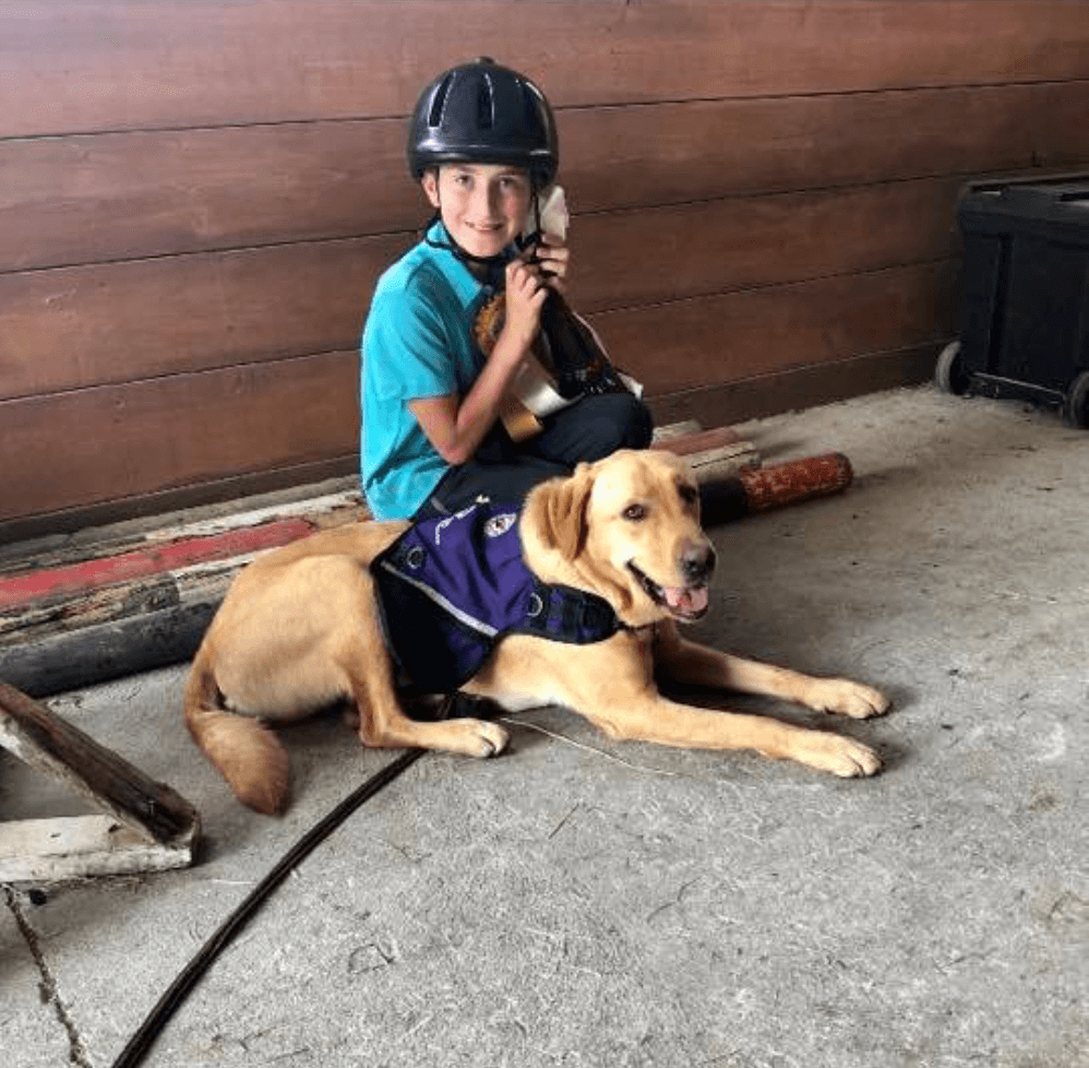 young boy hugging dog