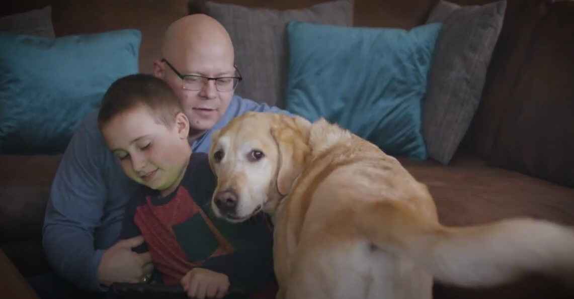 young boy hugging dog