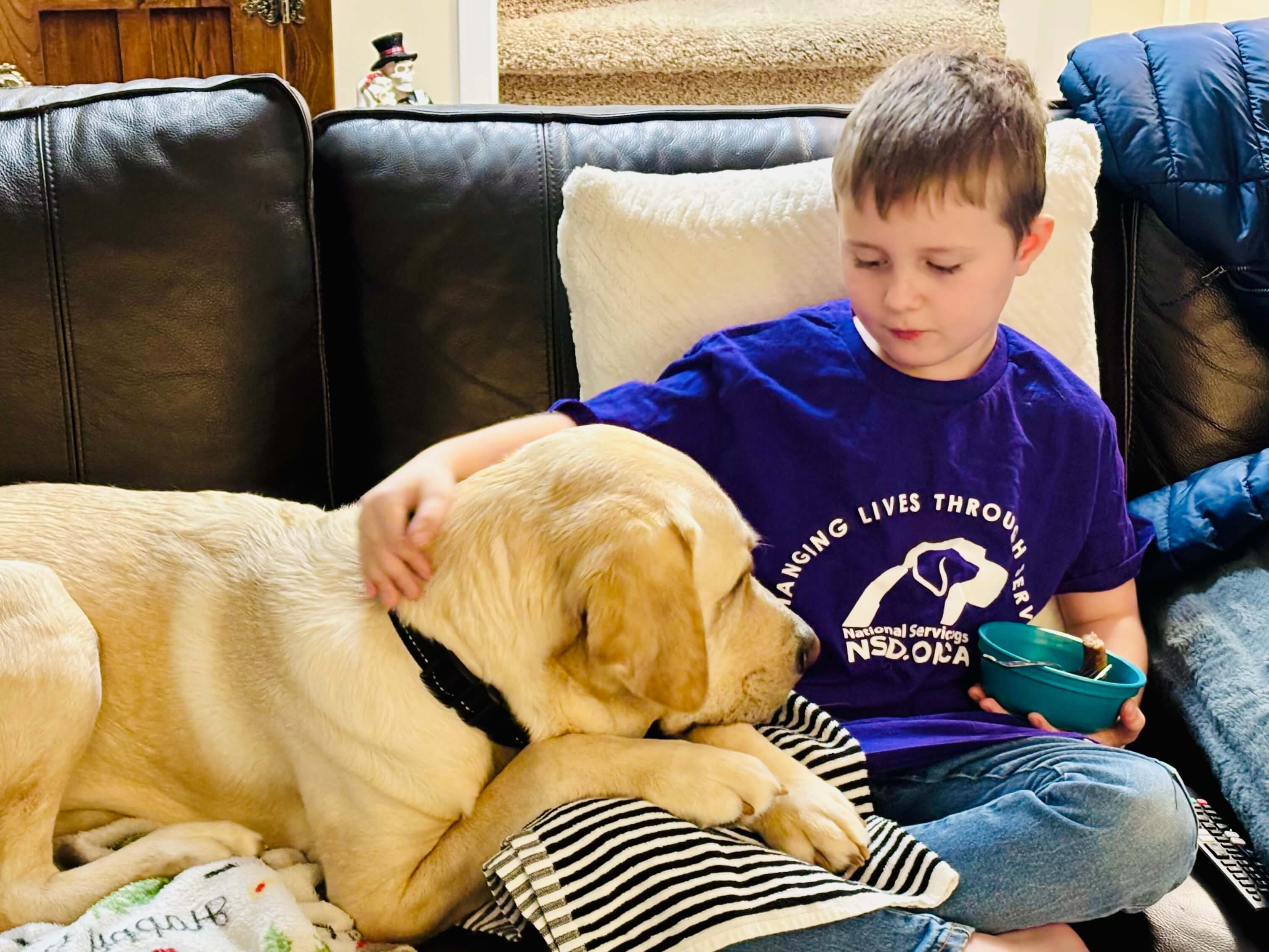 young boy hugging dog